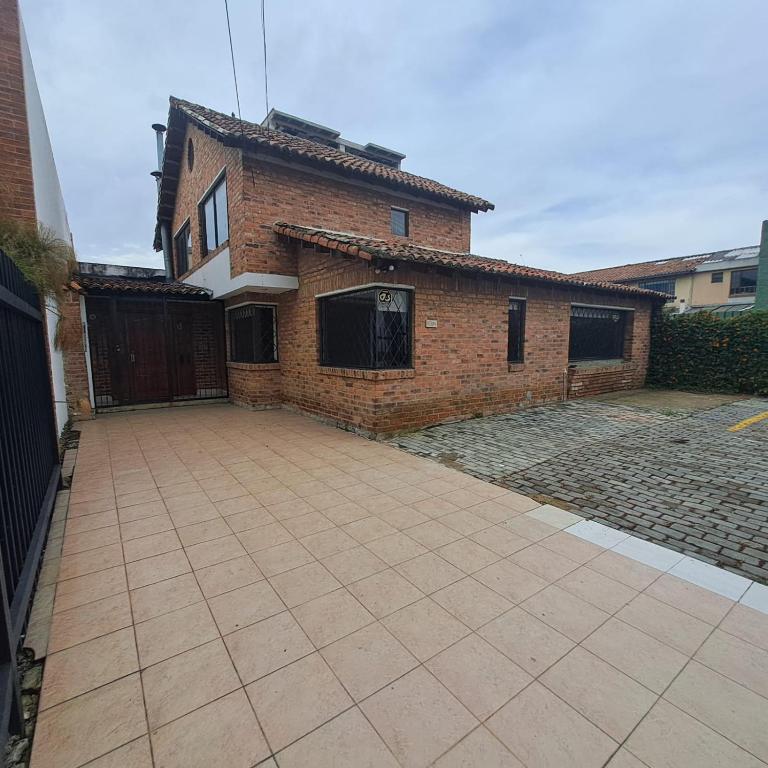 a brick house with a driveway in front of it at Fortaleza Diosa Chia in Chía