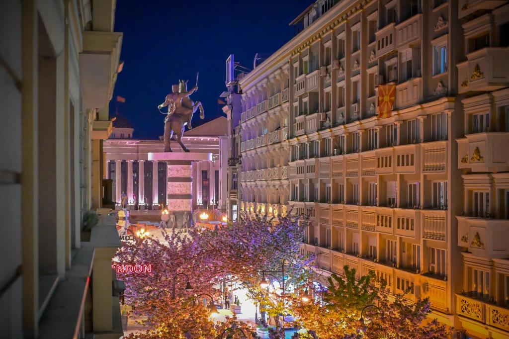 a view of a city street at night with a statue at Calla Bella Rooms & Snack Bar in Skopje