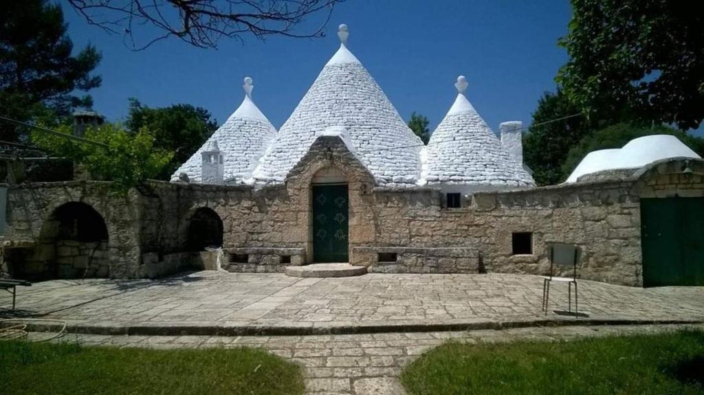 a castle style building with a door in a courtyard at Trullo Oasi di Pace in Ceglie Messapica