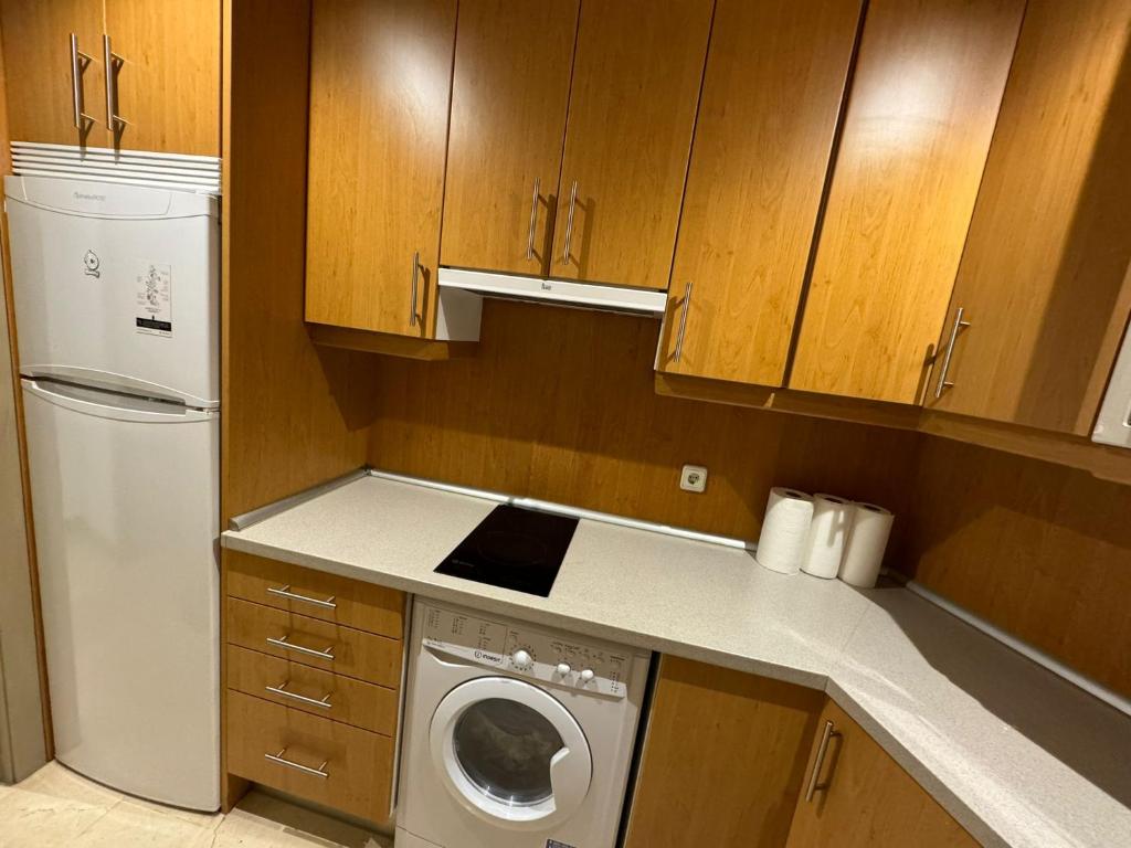 a kitchen with a washing machine and a washer at Hotelly Atocha in Madrid