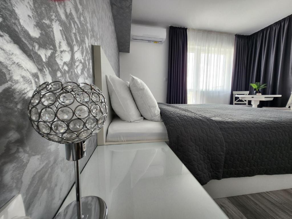 a hotel room with a bed and a couch at PANORAMNA -Guest Rooms in Veliko Tŭrnovo