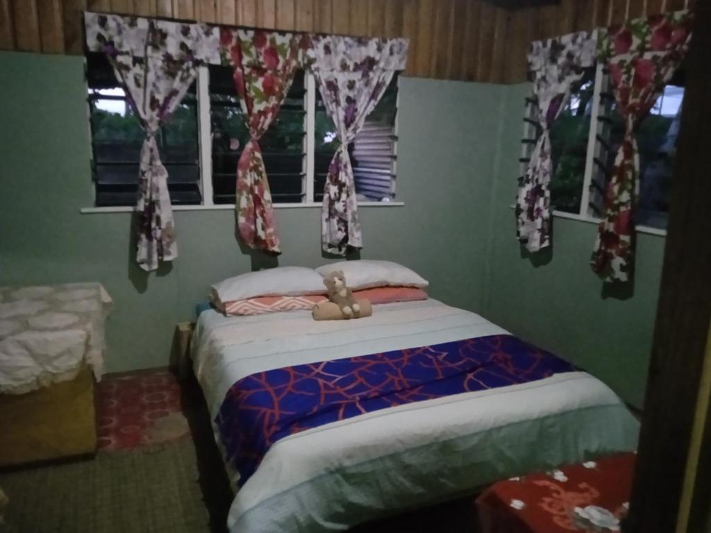 Un dormitorio con una cama con un osito de peluche. en AerowView Home Retreat en Matei