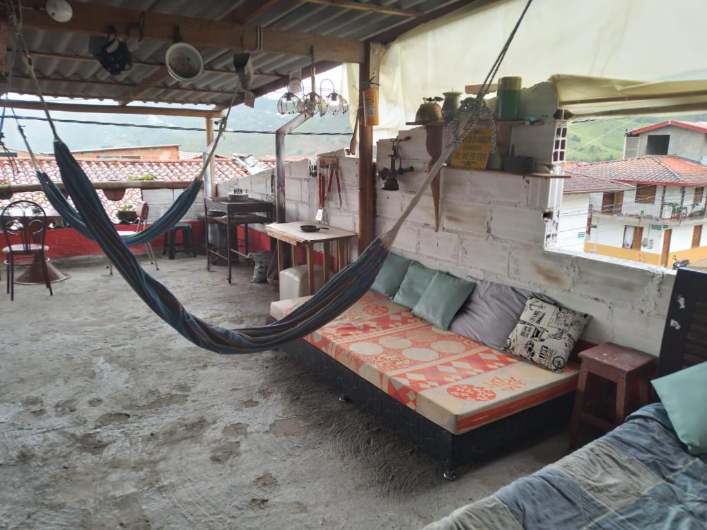 a hammock in a tent with a table and chairs at Casa de la Abuela in Jardin