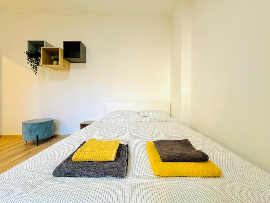 a bed with two towels on top of it at Golden Oasis in Belgrade