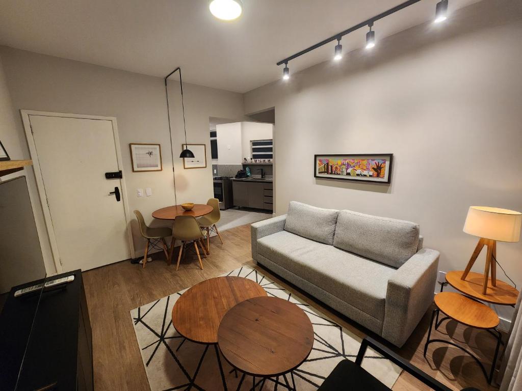 a living room with a couch and a table at Apartamento Modernizado in Rio de Janeiro