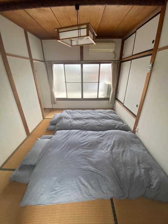 Postel nebo postele na pokoji v ubytování Izu-Nagaoka Base