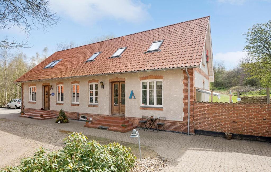 a small brick house with a red roof at 3 Bedroom Lovely Apartment In Engesvang in Engesvang