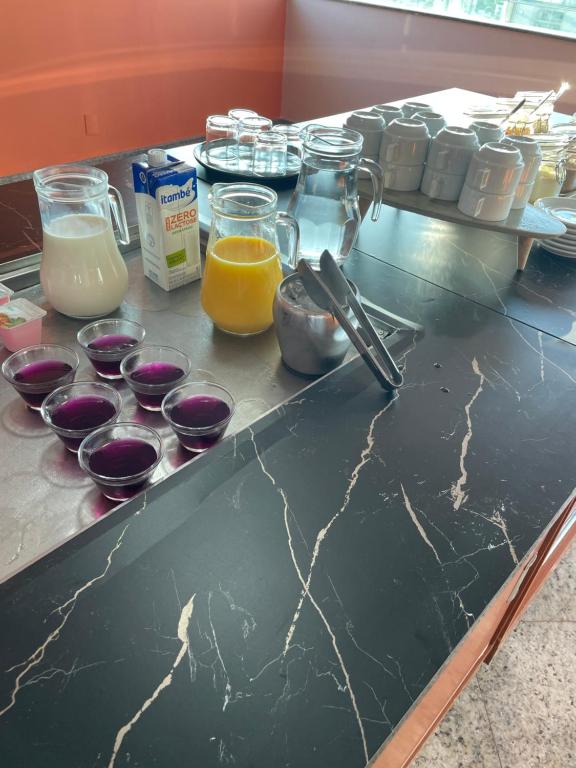 a counter with a bunch of ingredients on it at Abbas Hotel in Uberlândia