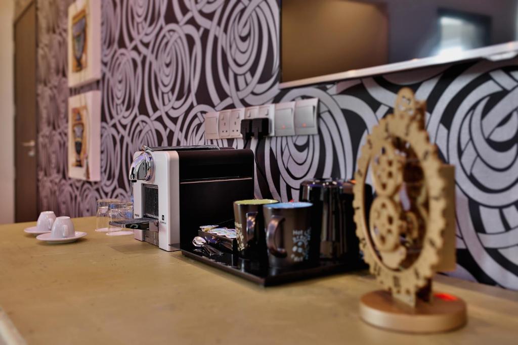 a kitchen counter with a microwave and a counter top with a counter top at The Josephine Boutique Hotel in Larnaka