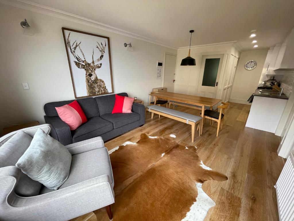 a living room with a couch and a table at Shamrock 1 in Mount Hotham