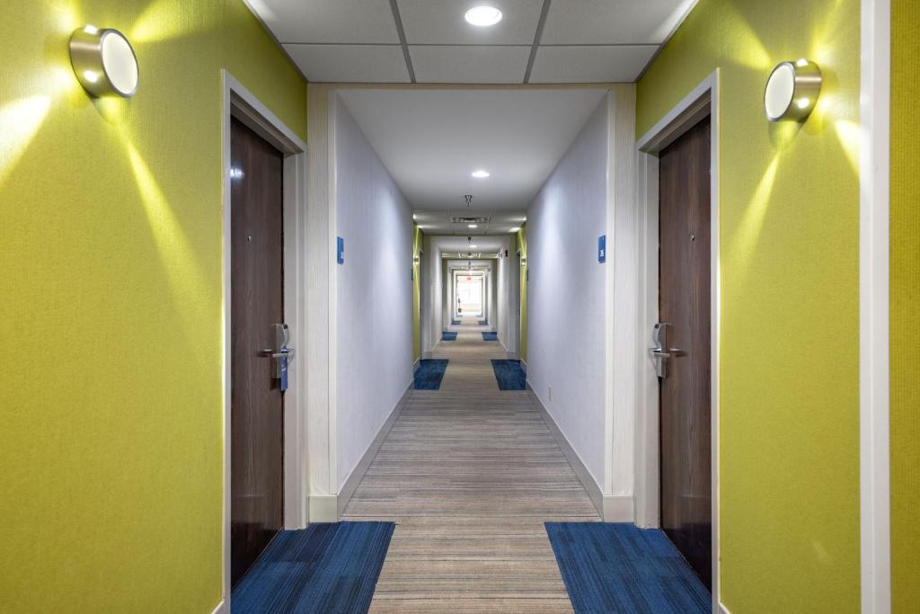 a corridor of an office with green walls and wooden floors at Holiday Inn Express & Suites Chattanooga-Hixson by IHG in Hixson