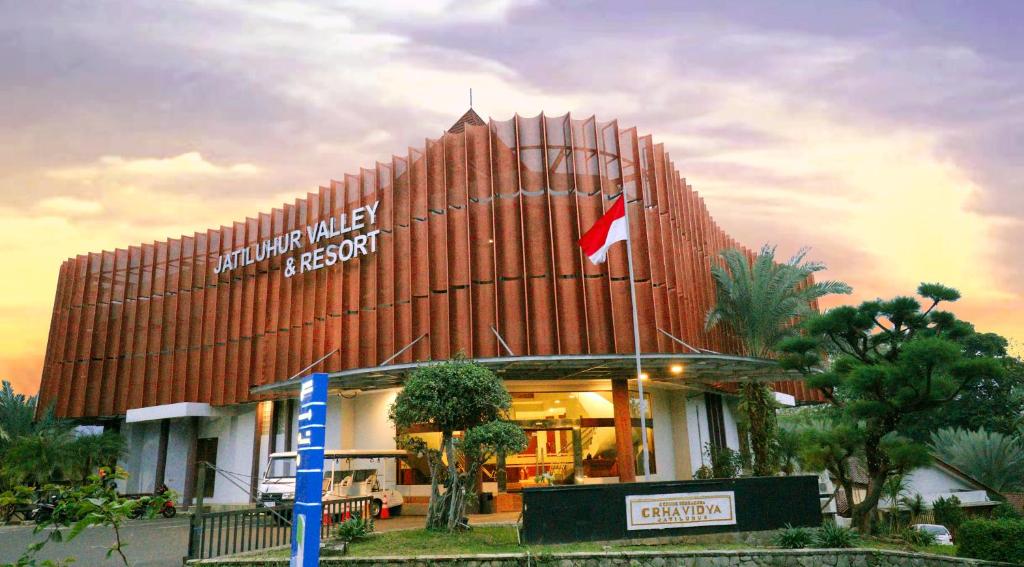 a building with a flag on the front of it at Jatiluhur Valley Resort in Purwakarta