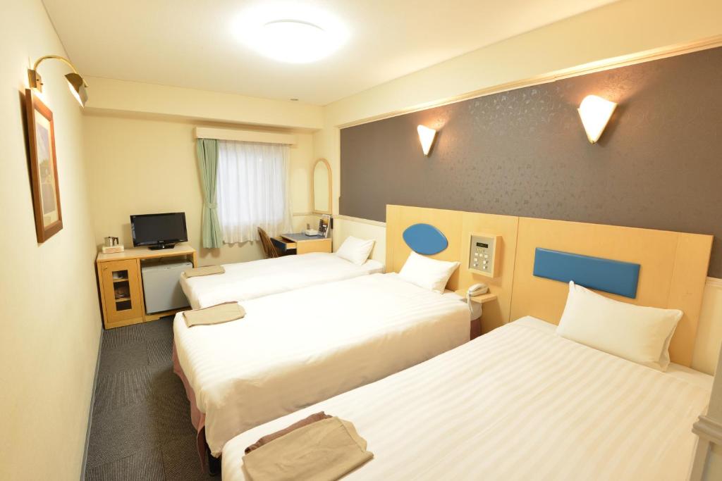 Postel nebo postele na pokoji v ubytování Hotel Marutani