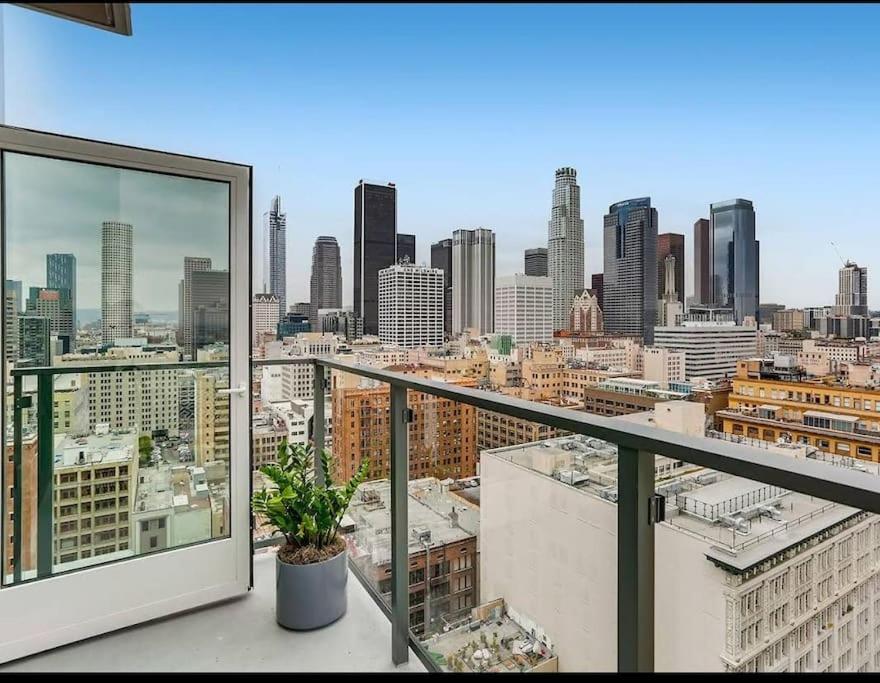 a view of a city skyline from a balcony at High Rise 3 Bedroom Sleeps 9 Walk to Cripto Arena in 20 Minutes in Los Angeles