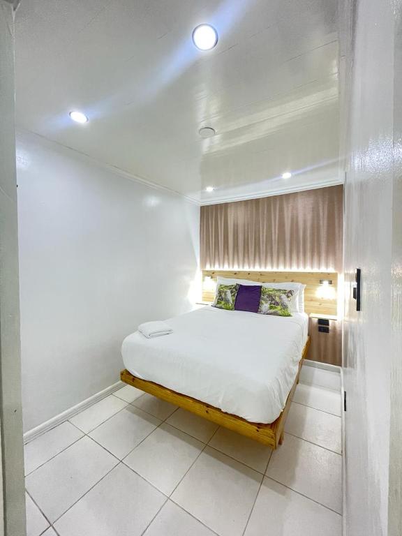 een slaapkamer met een bed in een kamer bij The Jazmin's apartments in Oranjestad