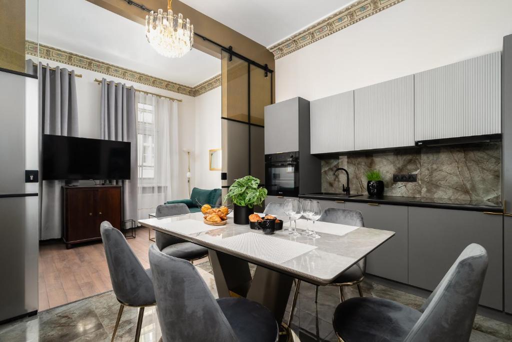 eine Küche und ein Esszimmer mit einem Tisch und Stühlen in der Unterkunft Glamour Apartament - Centrum Poznania in Posen