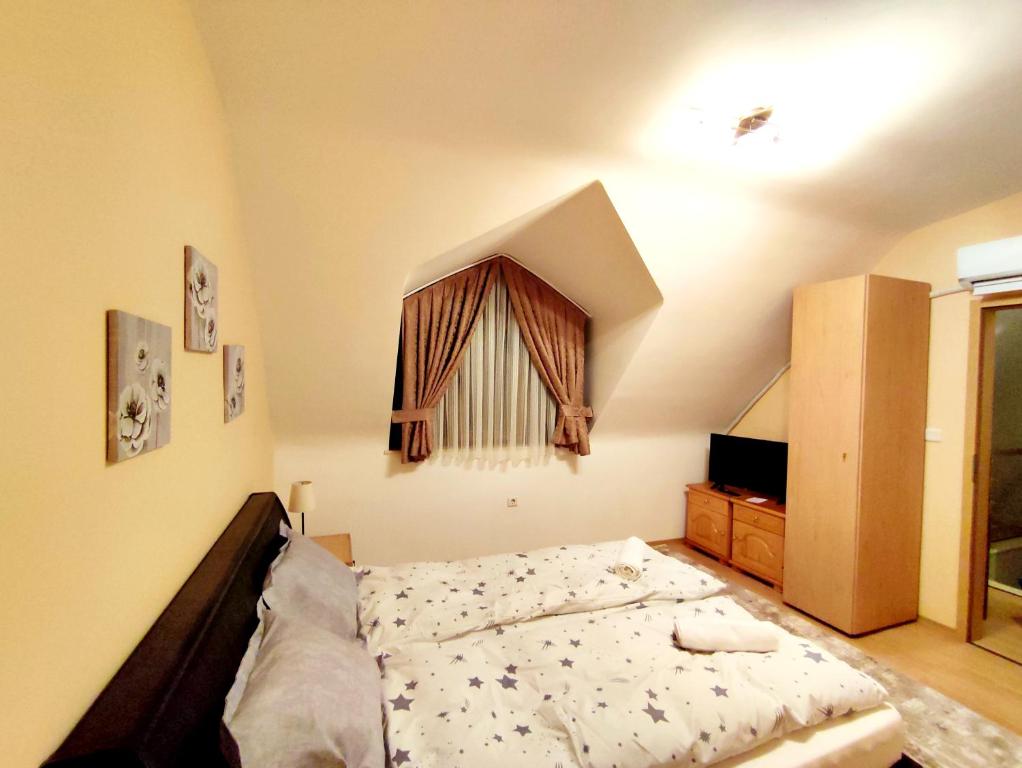 a bedroom with a bed and a window at Pirin Sunrise in Bansko