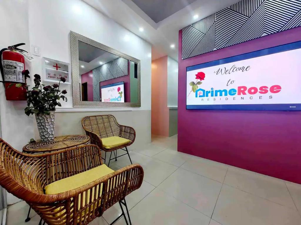 a salon with chairs and a purple wall at PrimeRose Residences in Lapu Lapu City