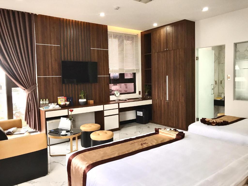 Postel nebo postele na pokoji v ubytování Anh Nguyet Da Nang Hotel