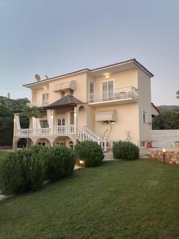 a large white house with a large yard at Villa Eleonas in Skala Kallirakhis