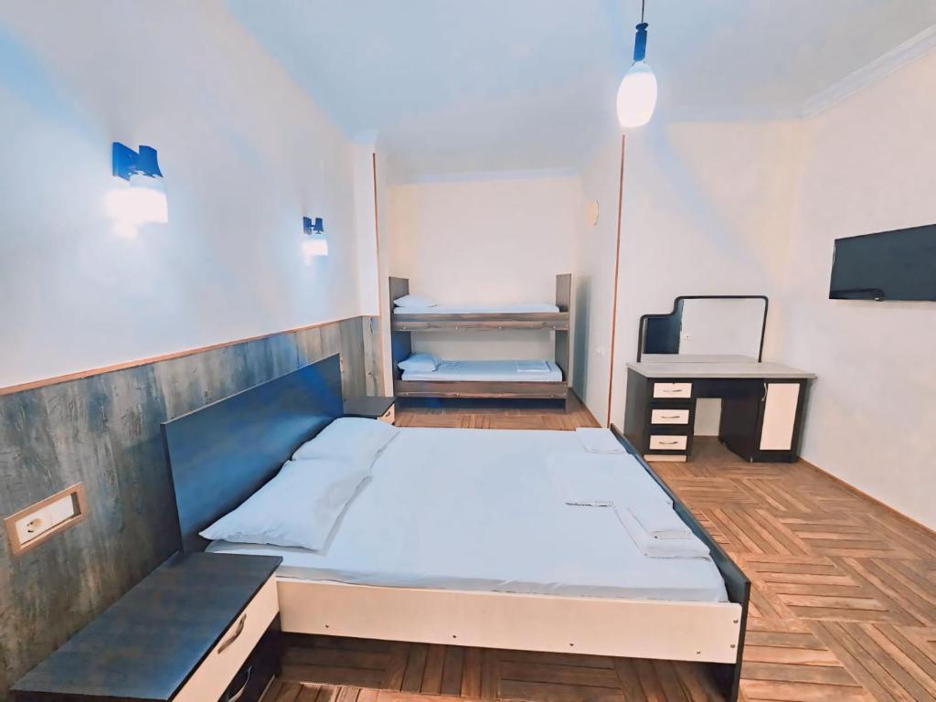 a room with a bed and a tv in it at Hotel Nine Brothers in Batumi