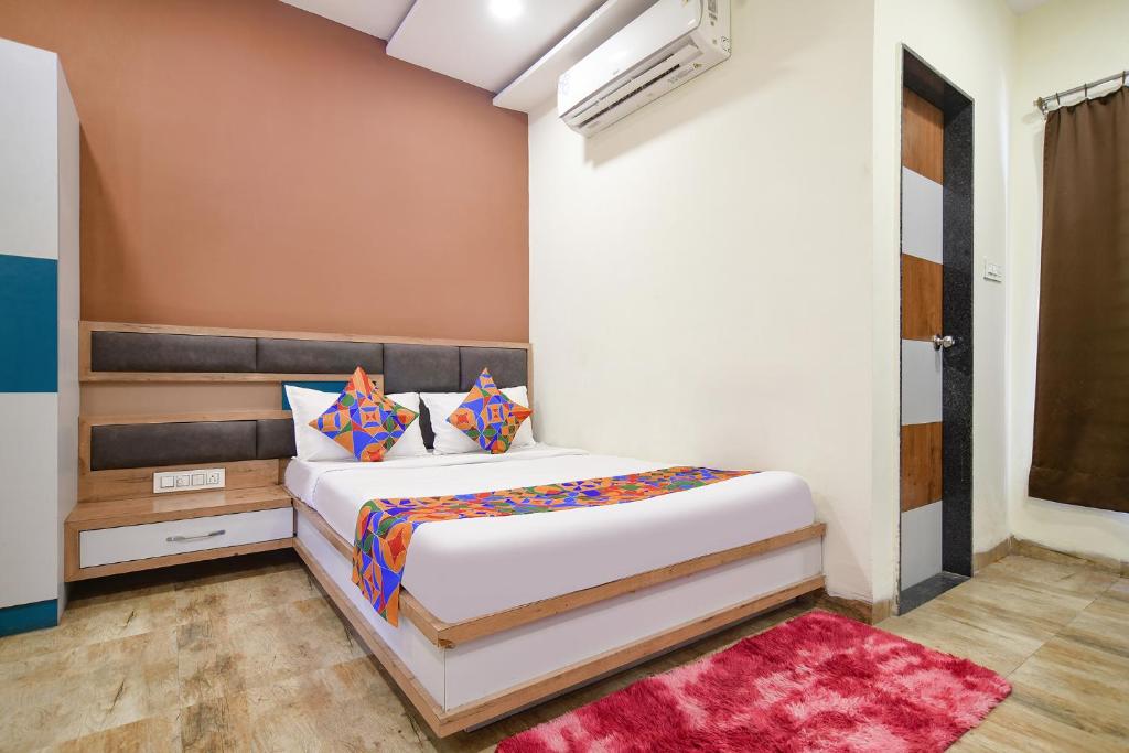 a bedroom with a large bed in a room at FabHotel SS Blue in Indore