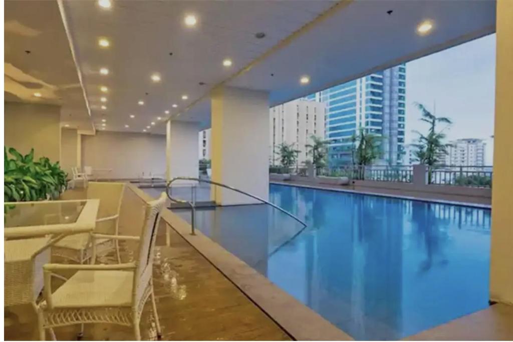 a swimming pool with a view of a building at Asuncion Apartment for Rent 