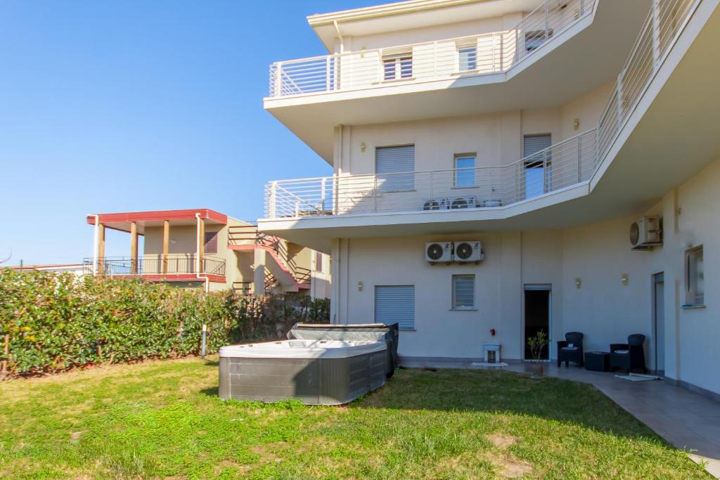 a view of a building with a yard at Eclisse House Few Steps From The Sea - Happy Rentals in Augusta