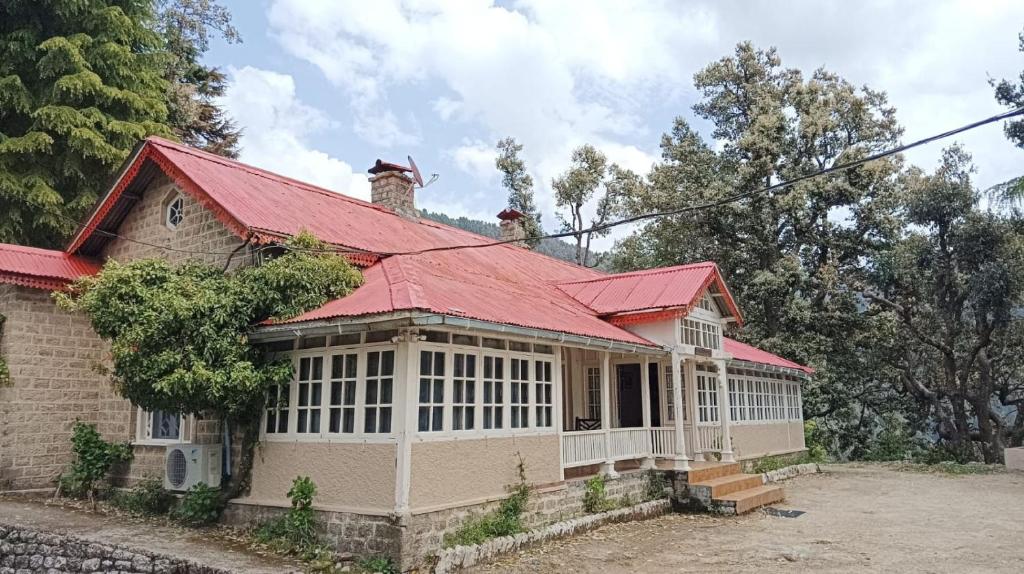 an old house with a red roof at Tansy Cottage in Dalhousie