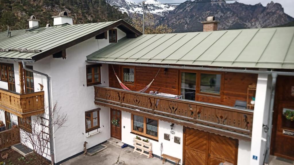 a house with a metal roof and a balcony at Schlafende Hexe in Bischofswiesen