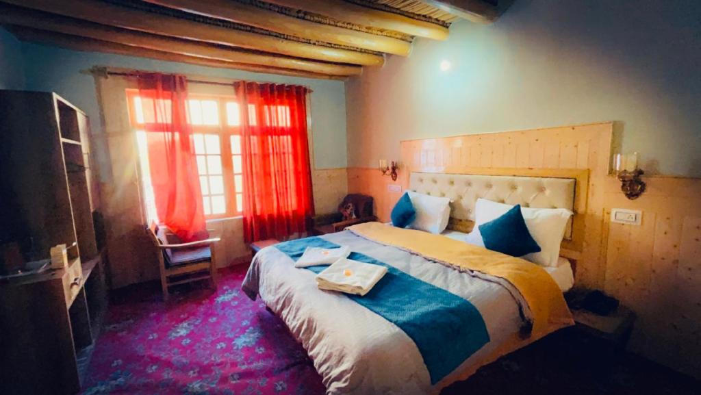 a bedroom with a large bed with a tray on it at Hotel Pangong Residency in Leh