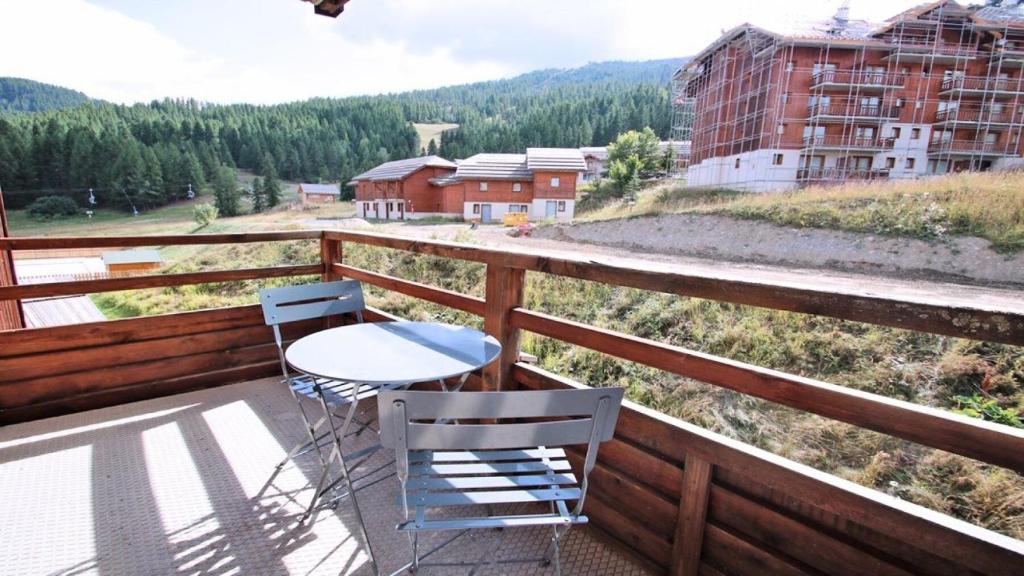 a table and two chairs on a balcony with a view at Résidence Dame Blanche - 2 Pièces pour 6 Personnes 414 in Narreyroux