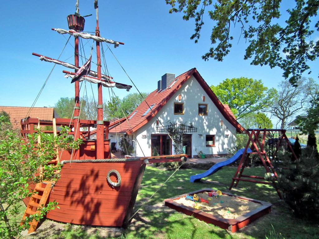 a house with a pirate ship and a playground at Haus Jasmin in Bodstedt