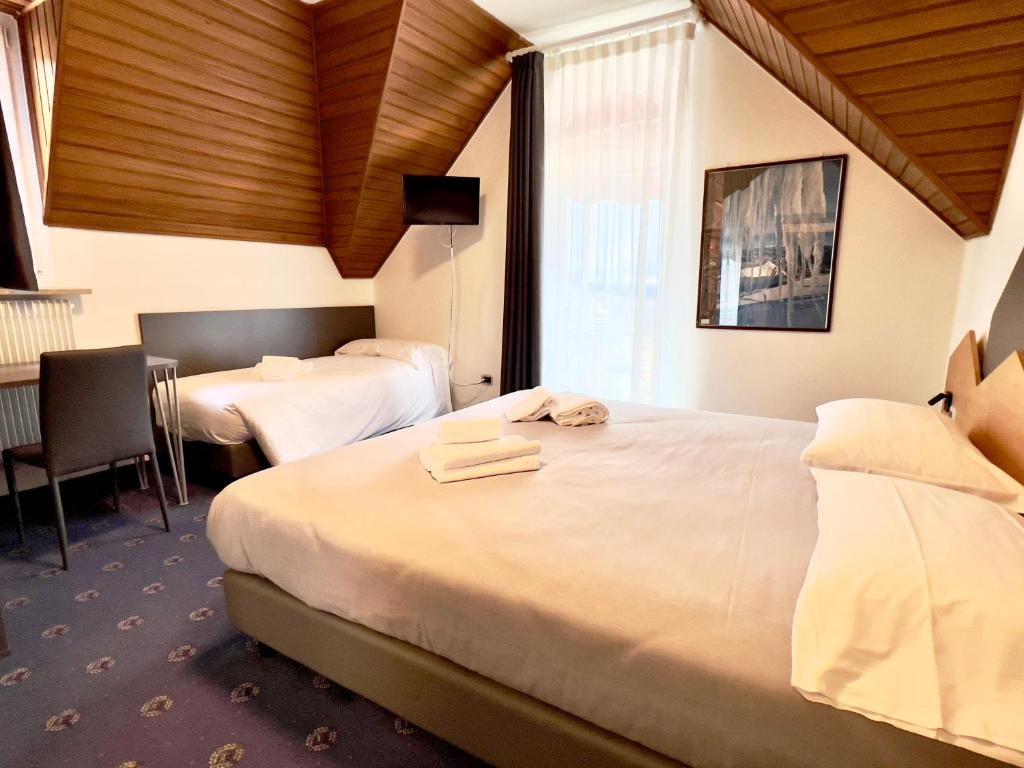 Giường trong phòng chung tại Hotel Regina del Bosco