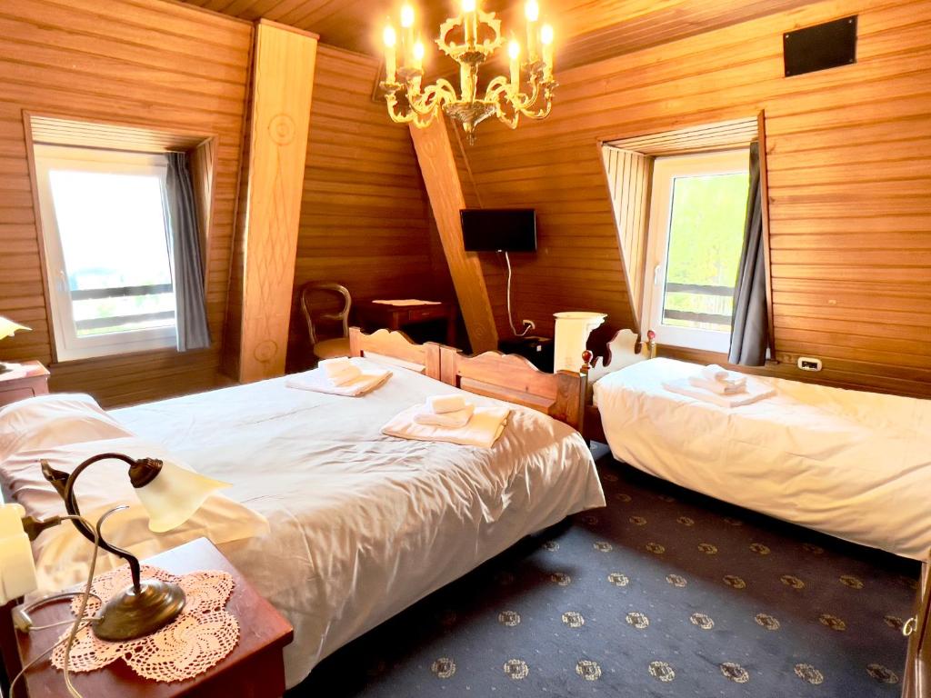 מיטה או מיטות בחדר ב-Hotel Regina del Bosco