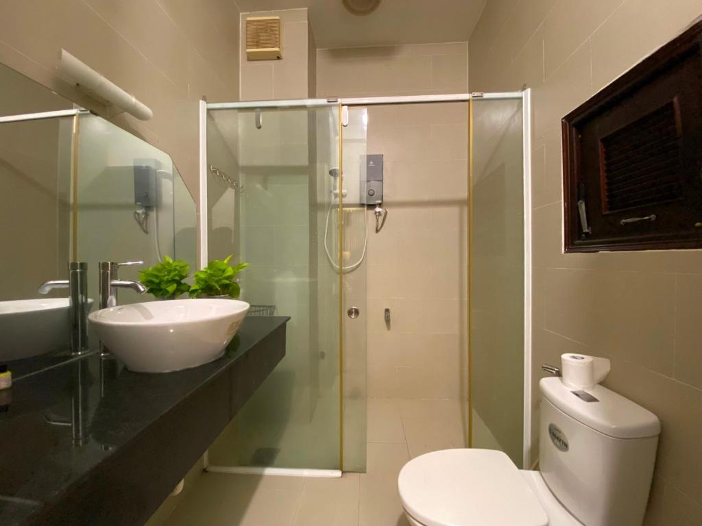 a bathroom with a toilet and a sink and a shower at A Little Saigon in Ho Chi Minh City