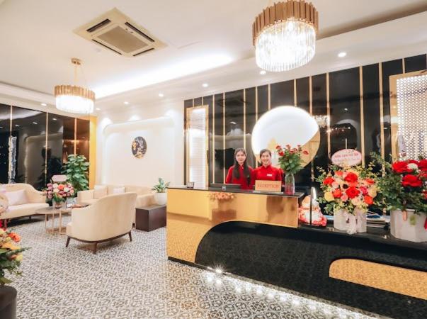 two women standing at a counter in a hotel lobby at Lake View Hotel & Travel in Hanoi