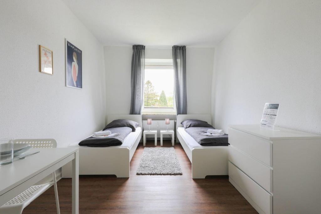 a small room with two beds and a desk at Apartment in Schwerte in Schwerte