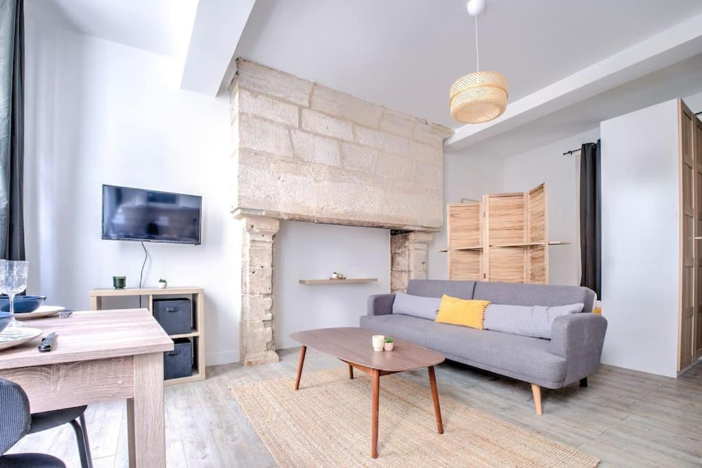 a living room with a couch and a table at Wisdom at heart in Périgueux