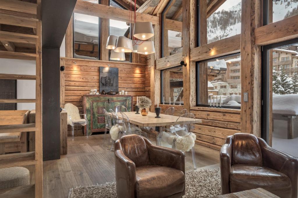 a dining room with a table and two chairs at Chalet Papillon - LES CHALETS COVAREL in Val dʼIsère