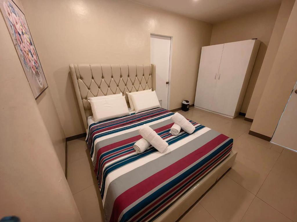 Voodi või voodid majutusasutuse PrimeRose Residences - Near Mactan-Cebu International Airport toas