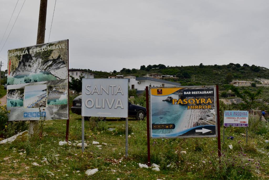 a group of signs on the side of a road at Ksamil Sea&Lake view Escape in Ksamil