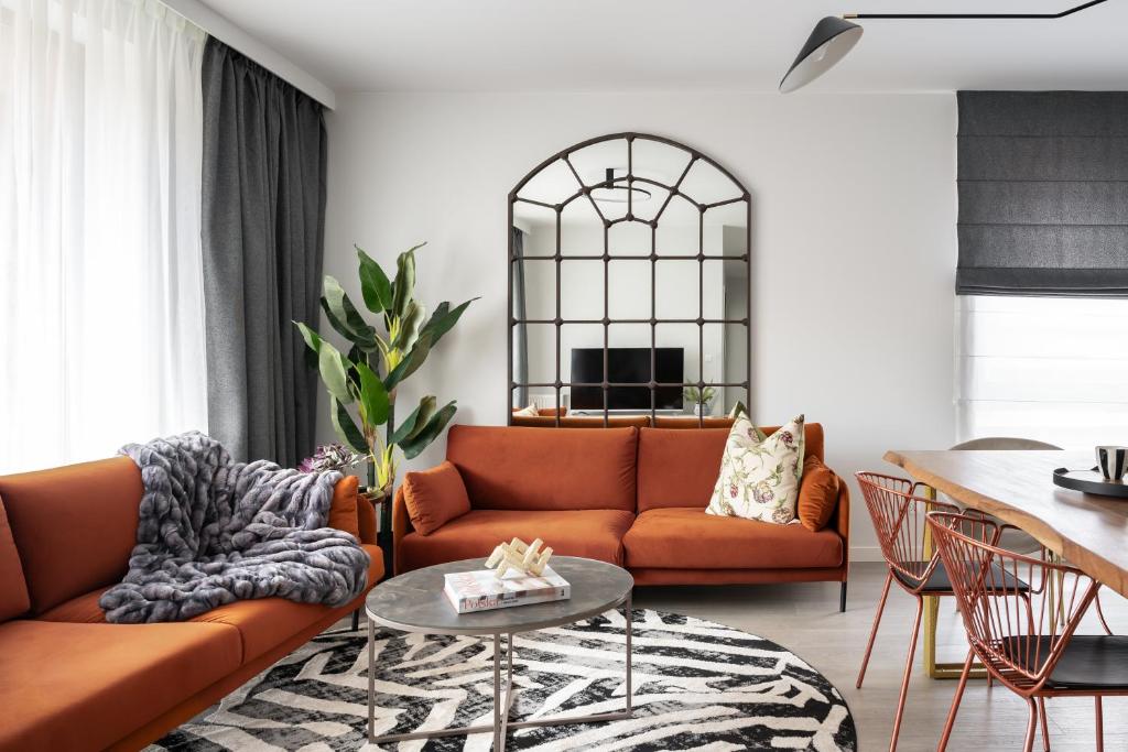a living room with a couch and a table at Lion Apartments - SCALA City Center Premium Apartments&Studio IID in Gdańsk