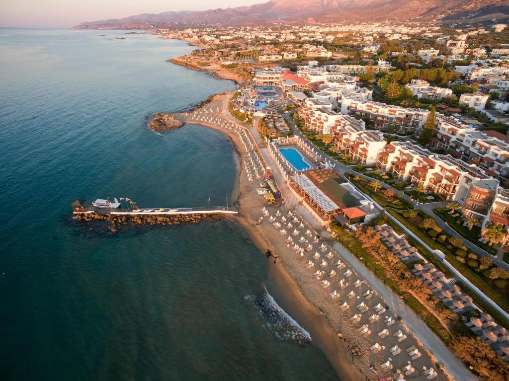 an aerial view of a beach with buildings and the ocean at Alexander Beach Hotel & Village Resort in Malia