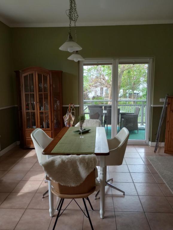 a dining room with a table and some chairs at AMBER LOGIA in Lubmin