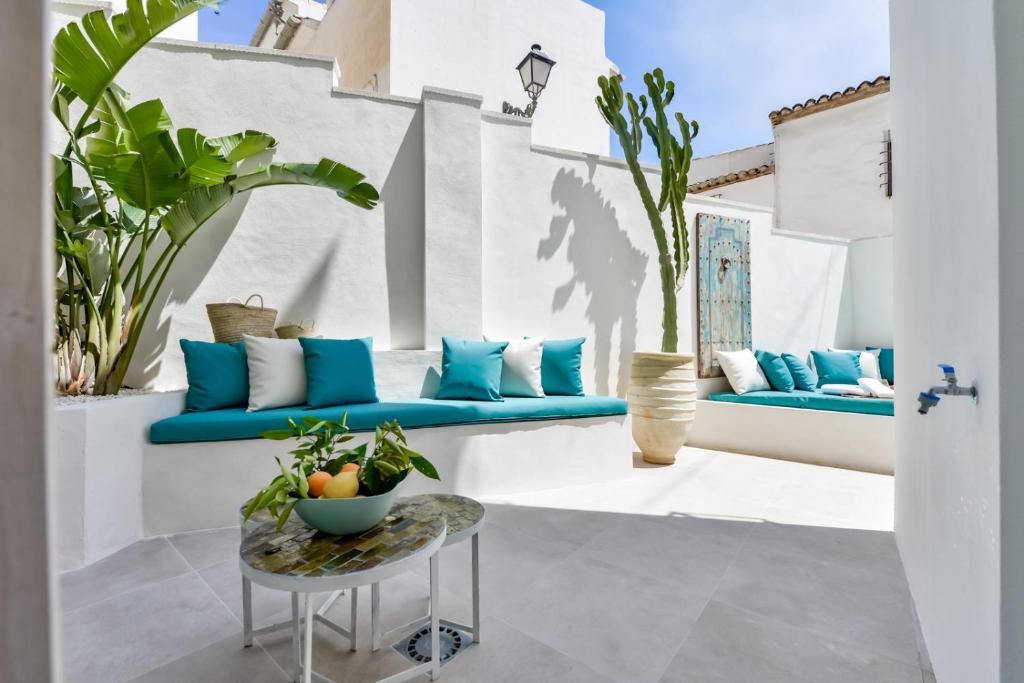a patio with blue couches and a table at MIMAR ALTEA ROOMS - Tranquil in Altea