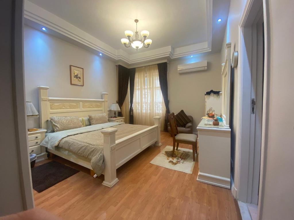a bedroom with a bed and a desk and a chair at Garden city 3 bedroom apartment in Cairo