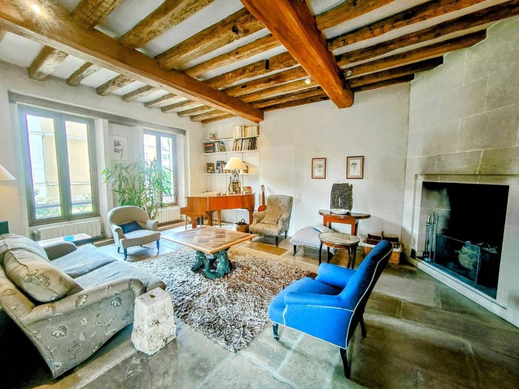 a living room with a couch and a fireplace at Home - Visitandines - Séjour à Auxerre in Auxerre