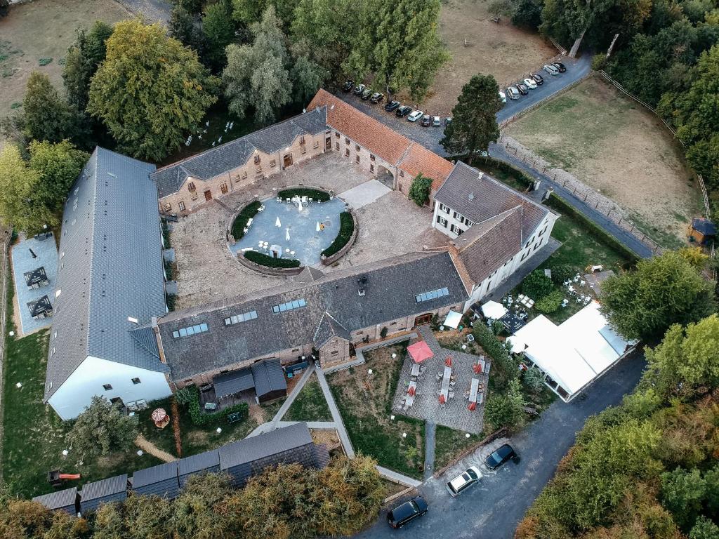 an overhead view of a large building with a swimming pool at Gut Hohenholz in Bedburg