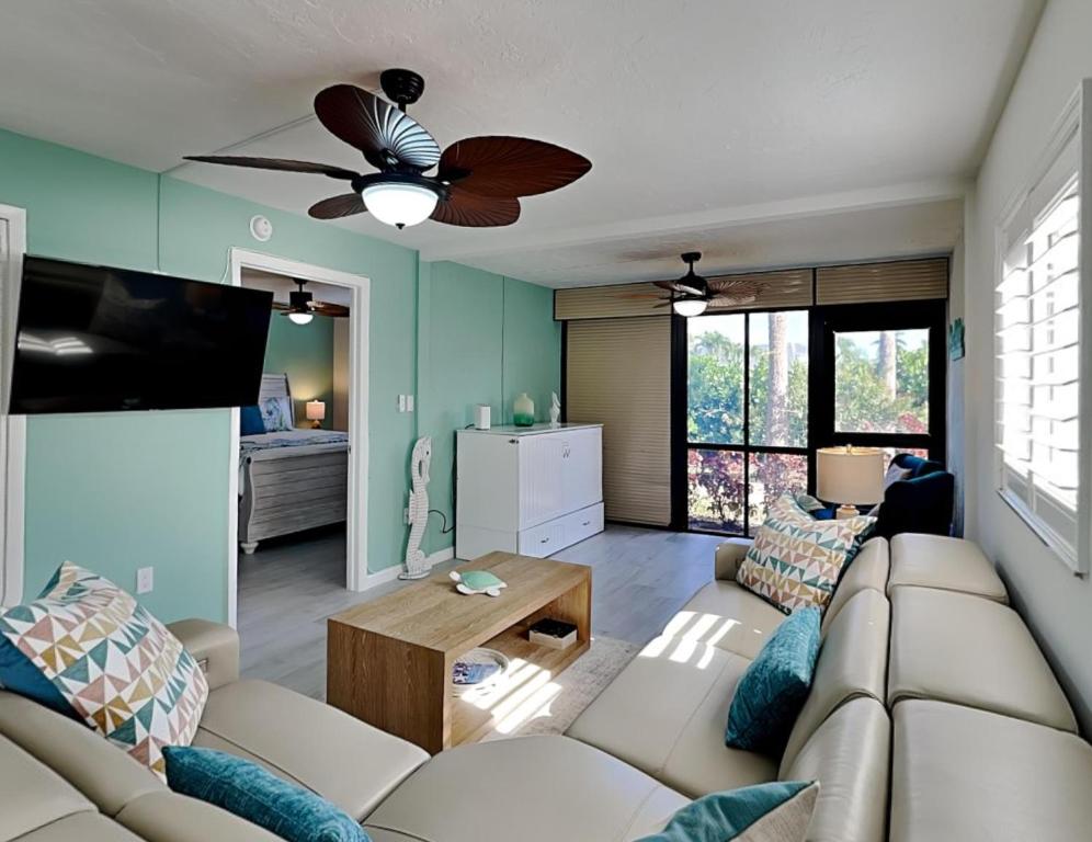 a living room with a couch and a ceiling fan at Casa Bella 105 in Fort Myers